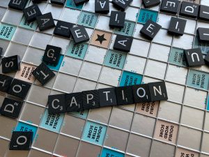 Image of a gaming tiles forming the word "caption"